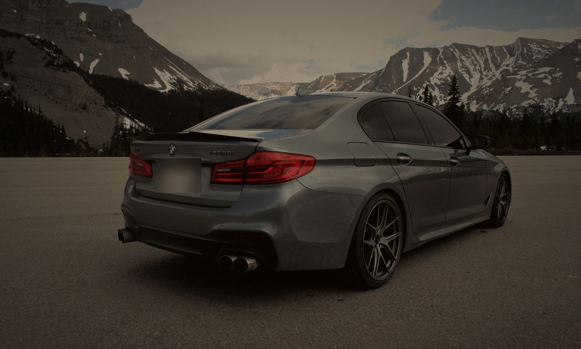 Space grey sedan from behind, parked below snow-capped Rockies, Bay9 Garage Labs Co.